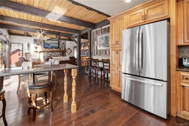 kitchen with stainless steel fridge, plenty of natural light, and dark hardwood / wood-style flooring