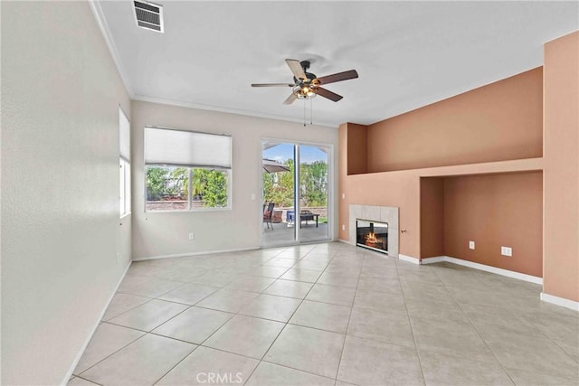 unfurnished living room with light tile patterned floors, visible vents, a tiled fireplace, ceiling fan, and baseboards