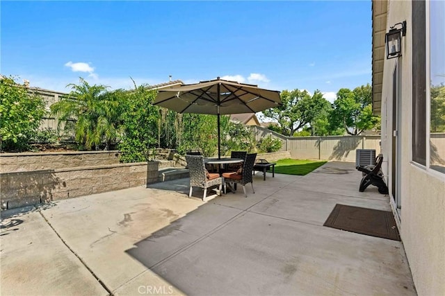 view of patio with a fenced backyard and outdoor dining space