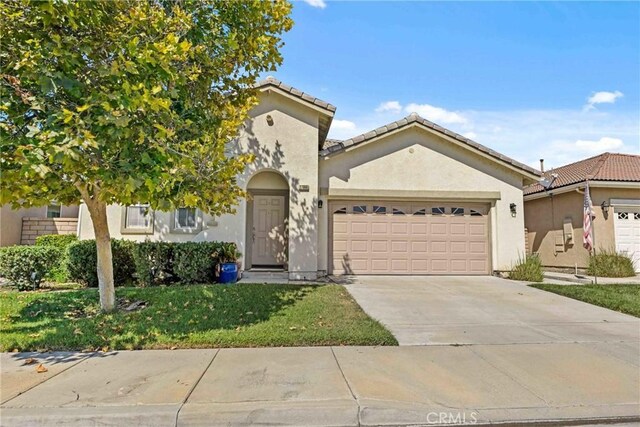 view of front of home with a garage and a front yard