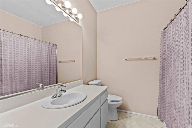 full bath featuring toilet, vanity, and tile patterned floors