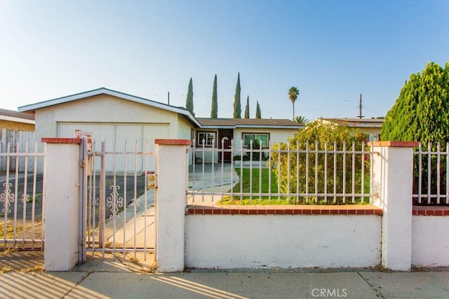 ranch-style house with a fenced front yard and a gate