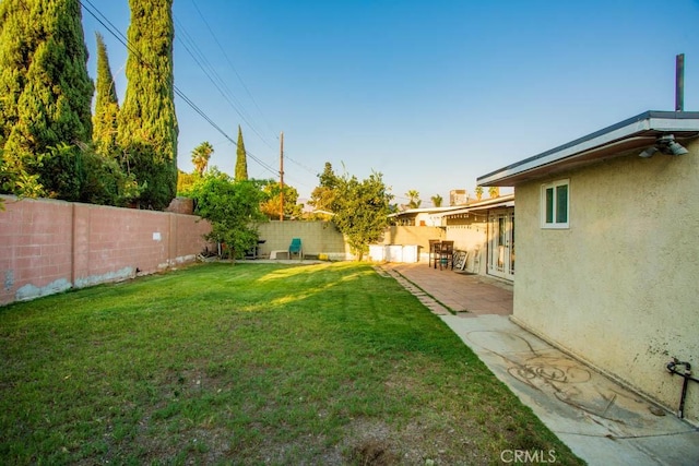 view of yard with a fenced backyard and a patio