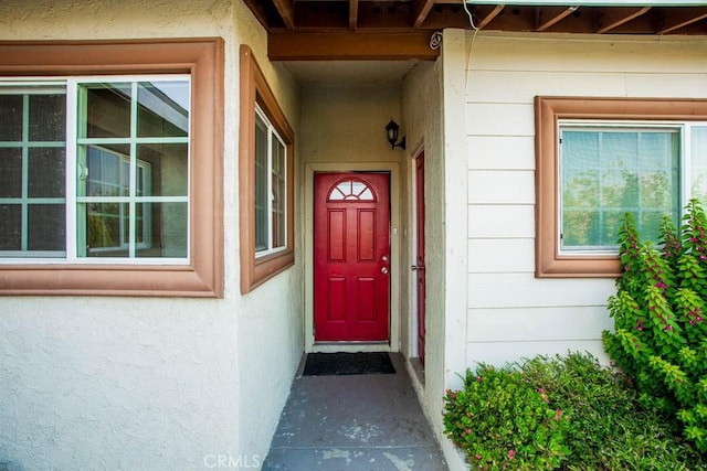 entrance to property with stucco siding