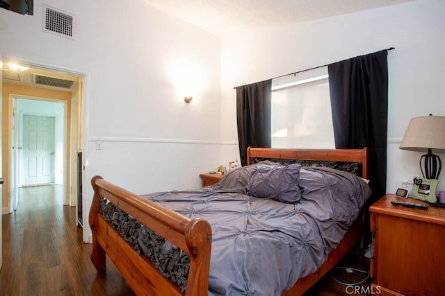 bedroom featuring dark wood-style floors and visible vents