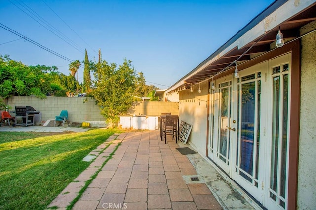 view of patio / terrace with french doors, a fenced backyard, visible vents, and area for grilling