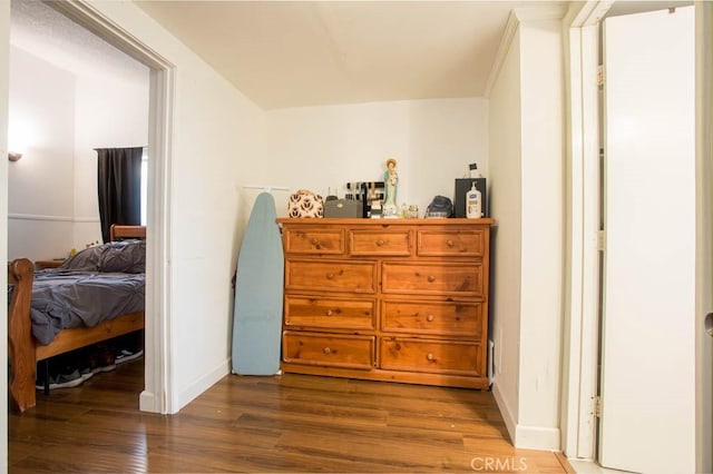 bedroom with baseboards and wood finished floors