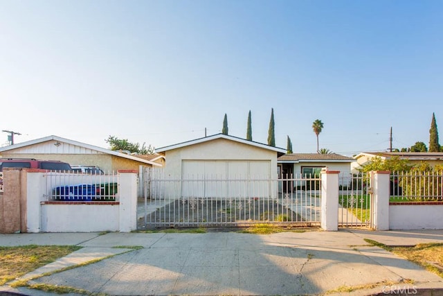 view of front of property with a garage, a fenced front yard, and stucco siding