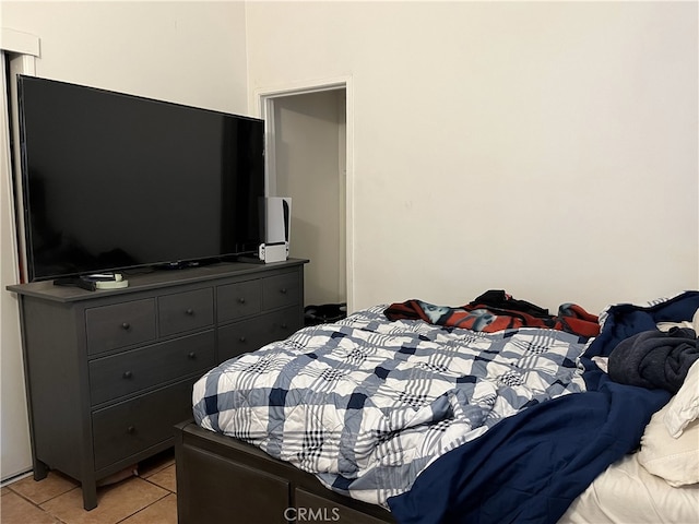 bedroom with light tile patterned floors