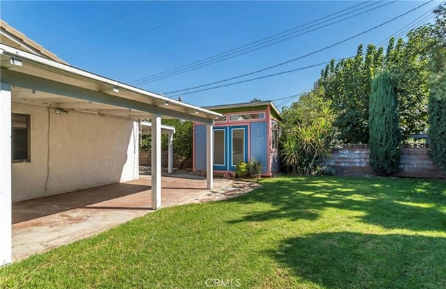 view of yard with a patio and a storage shed