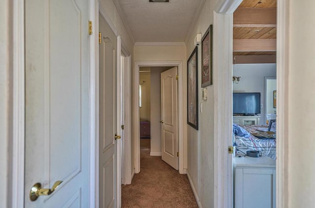 corridor featuring ornamental molding and light colored carpet