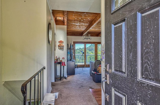 hallway featuring wood ceiling, carpet, and beam ceiling