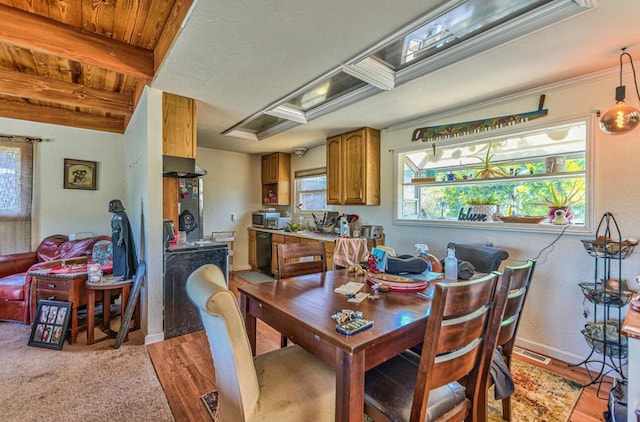 dining area featuring light hardwood / wood-style floors, beamed ceiling, and wooden ceiling