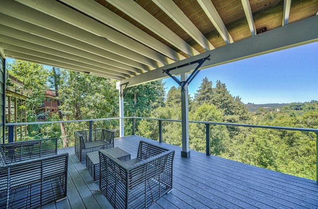 wooden terrace with an outdoor living space