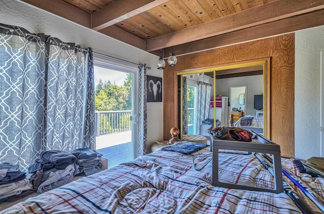 bedroom featuring beamed ceiling, access to exterior, a closet, and wooden ceiling