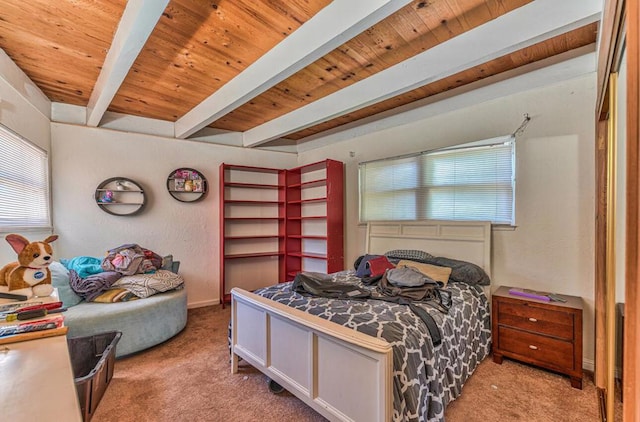 bedroom with beamed ceiling, light colored carpet, and wooden ceiling