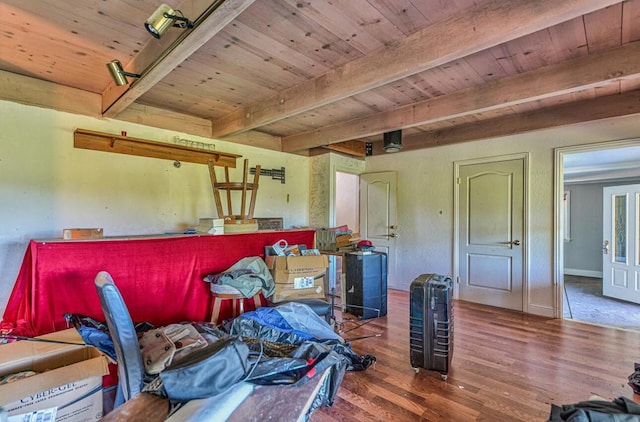 interior space with beam ceiling, wood-type flooring, and wooden ceiling