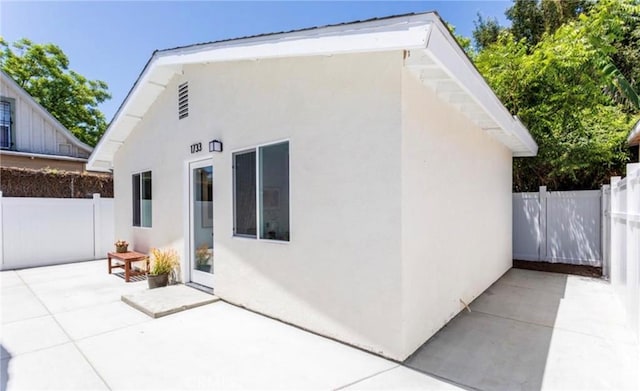 back of property featuring a patio area, a fenced backyard, and stucco siding