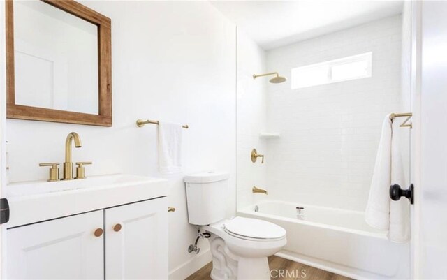 full bathroom with vanity, hardwood / wood-style floors, toilet, and shower / bathtub combination