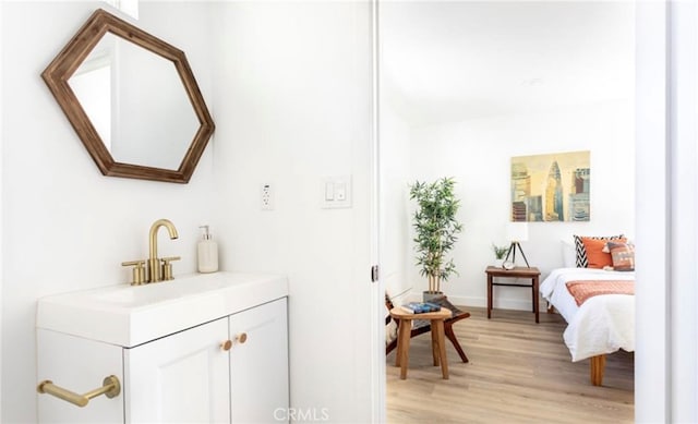 bathroom with vanity and wood-type flooring