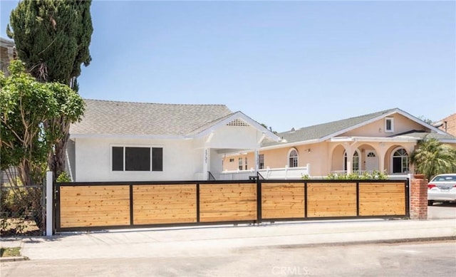 view of front of house featuring a fenced front yard and stucco siding