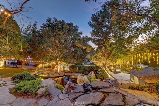 yard at dusk with a patio