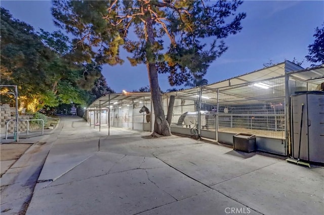 property exterior at dusk with an outbuilding