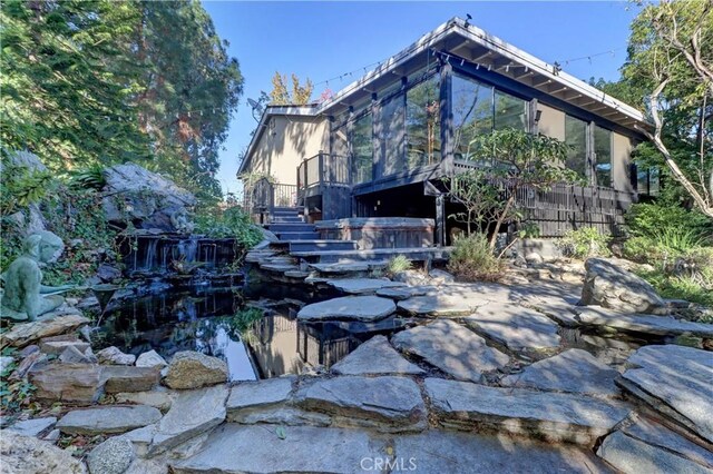 view of side of home featuring a jacuzzi