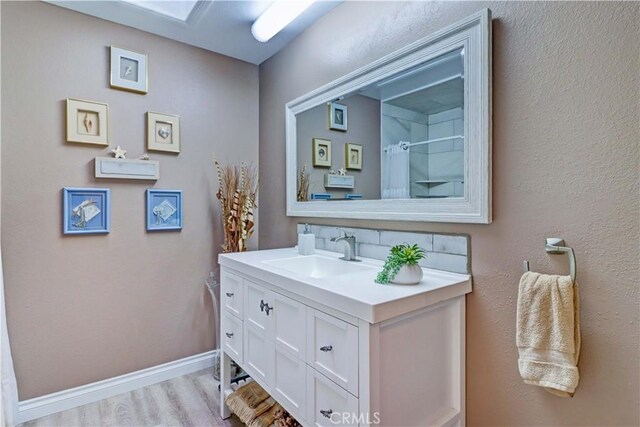 bathroom featuring vanity and hardwood / wood-style floors