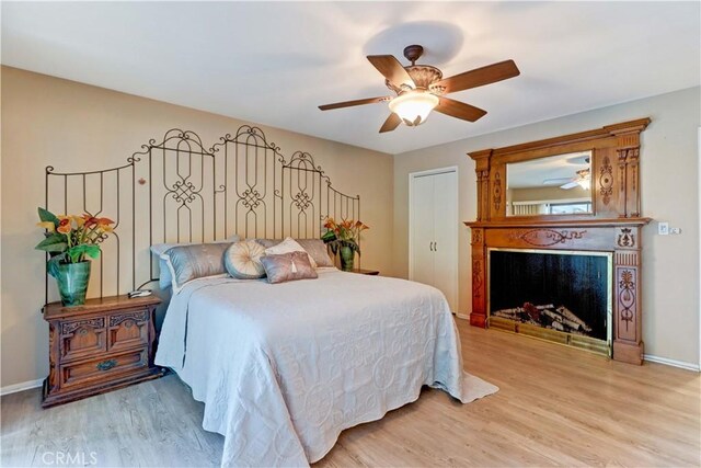 bedroom with ceiling fan and light wood-type flooring