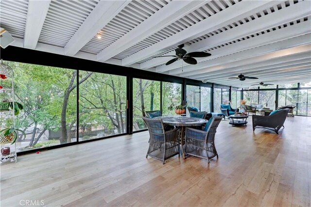 sunroom / solarium with ceiling fan and beam ceiling