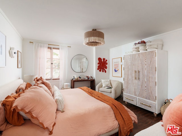 bedroom featuring dark wood-type flooring and crown molding