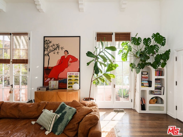 interior space with access to exterior, beamed ceiling, dark wood-type flooring, and french doors