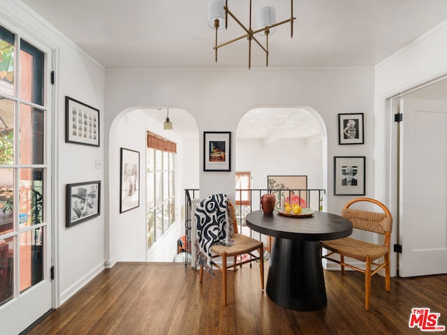 dining room featuring crown molding, a chandelier, and dark hardwood / wood-style floors