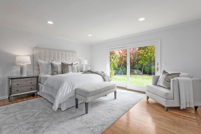 bedroom with light hardwood / wood-style flooring, ornamental molding, and access to outside