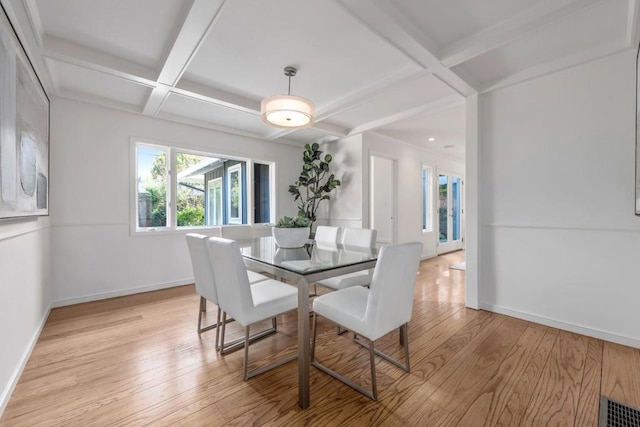 dining space with coffered ceiling, light hardwood / wood-style flooring, and beam ceiling