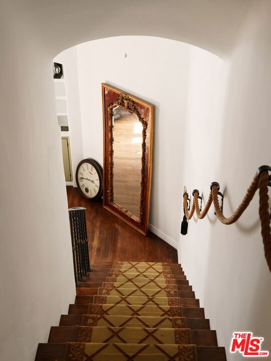 staircase featuring hardwood / wood-style flooring