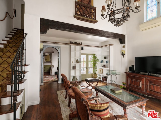 living room with french doors, beamed ceiling, and dark hardwood / wood-style floors