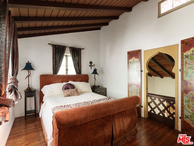 bedroom featuring dark wood-type flooring, lofted ceiling with beams, and wood ceiling