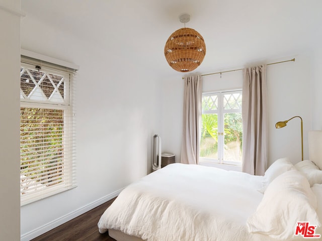 bedroom with dark wood-type flooring