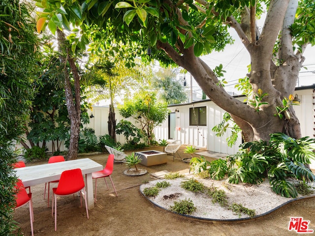 view of yard with a patio area and an outdoor fire pit