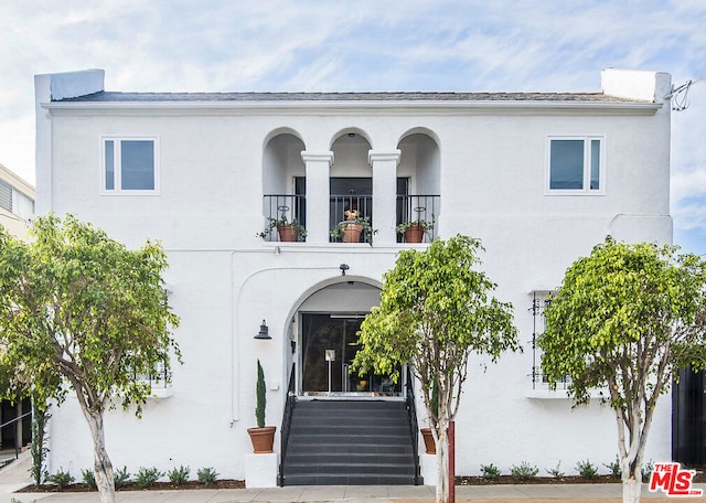 view of front of house featuring a balcony