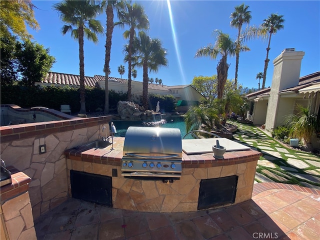 view of patio with area for grilling and a grill