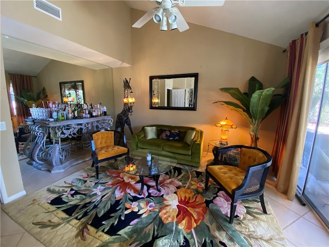 tiled living room with ceiling fan and vaulted ceiling