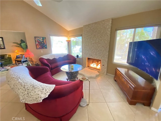 living room with lofted ceiling, light tile patterned flooring, and a fireplace