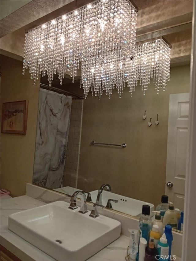 bathroom featuring vanity and a notable chandelier