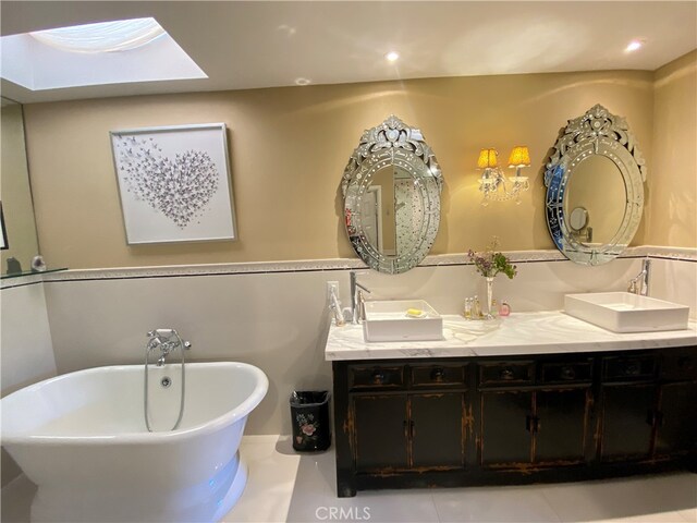 bathroom featuring vanity, tile patterned flooring, and a bathing tub