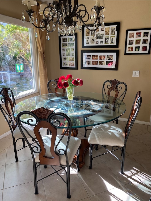 tiled dining space with an inviting chandelier and a healthy amount of sunlight