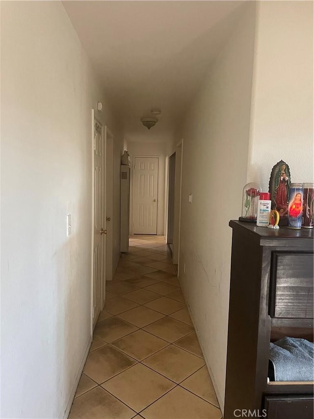 corridor featuring light tile patterned floors