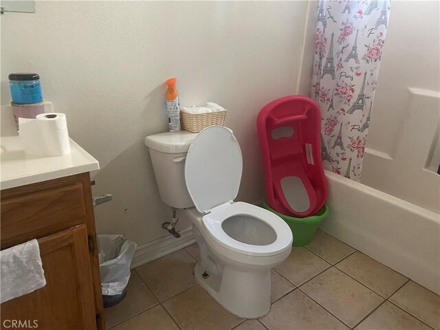 full bathroom with tile patterned flooring, vanity, shower / tub combo with curtain, and toilet